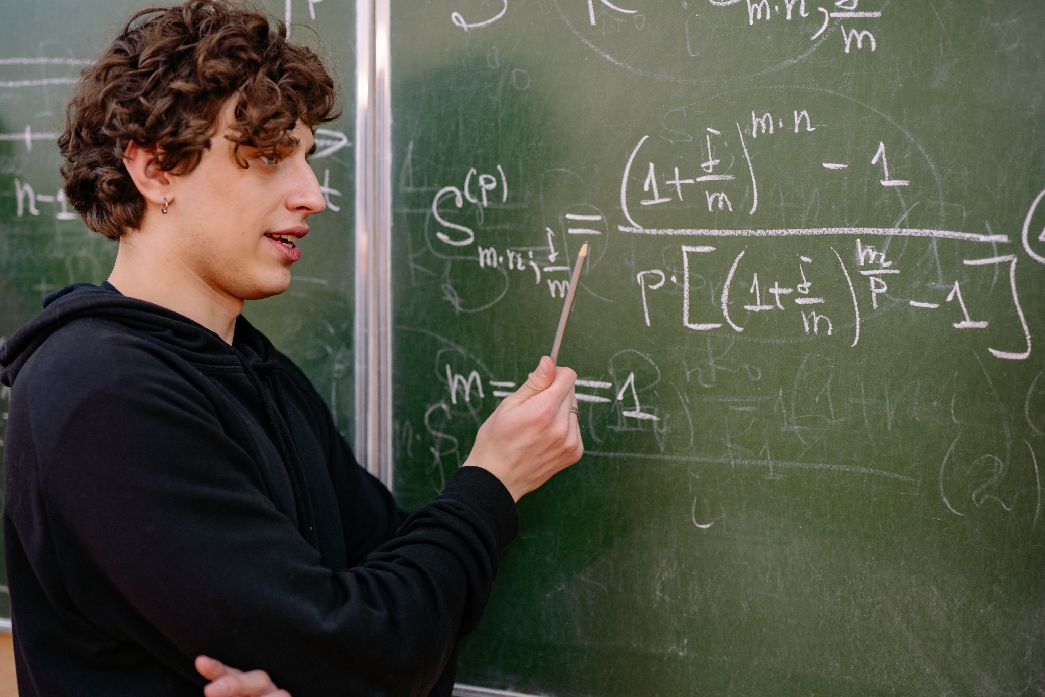 Student explaining mathematics at a chalkboard